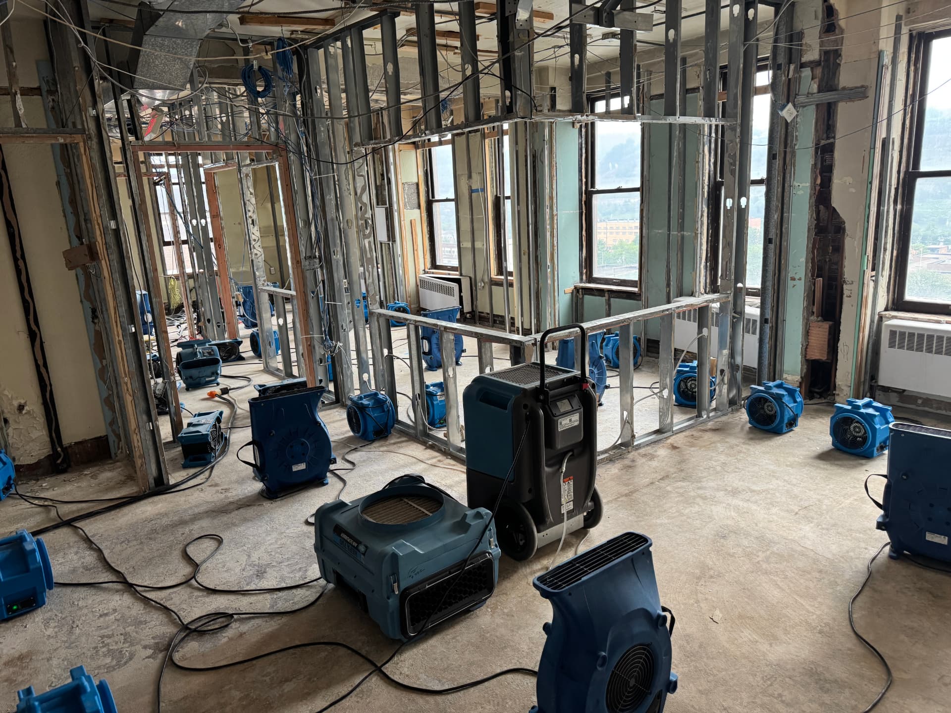 Large loss commercial water damage with dehumidifier and dozens of air movers deployed