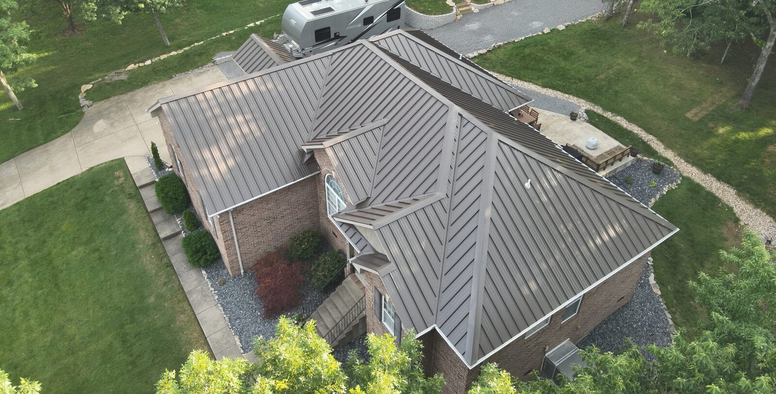Standing seam metal roof — brick home