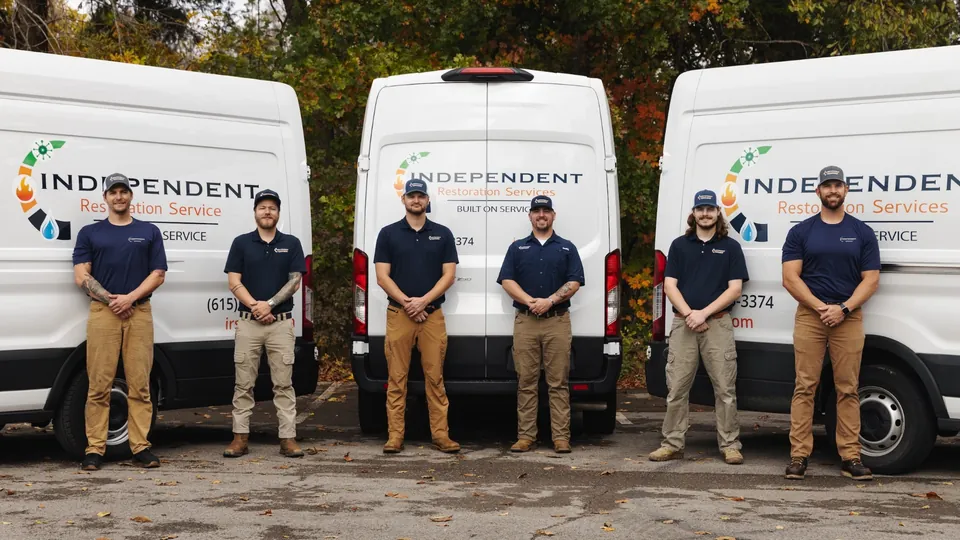 IRS restoration team standing in front of service vehicles