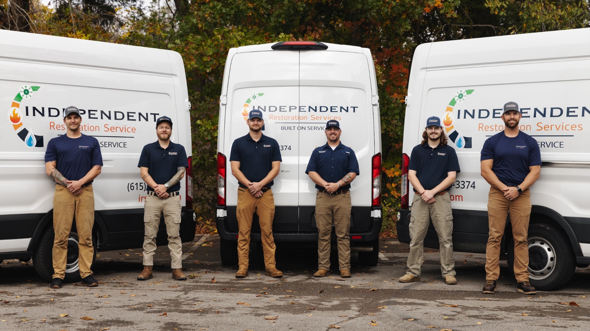 IRS restoration team standing in front of service vehicles